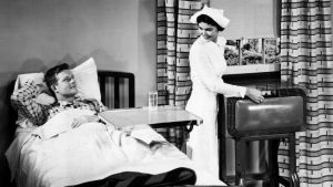 A nurse adjusts the air conditioning for the comfort of the patient in a hospital room during the 1950s. By 1953, over 1 million air conditioning units had been sold in the U.S.